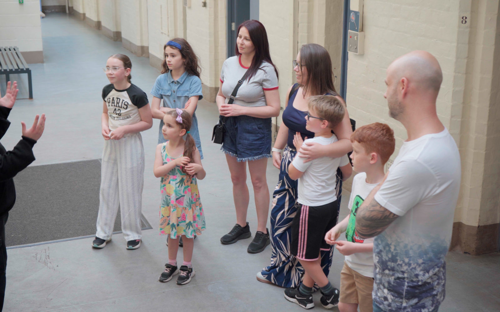 Family stood around prison officer during a Guided Tour