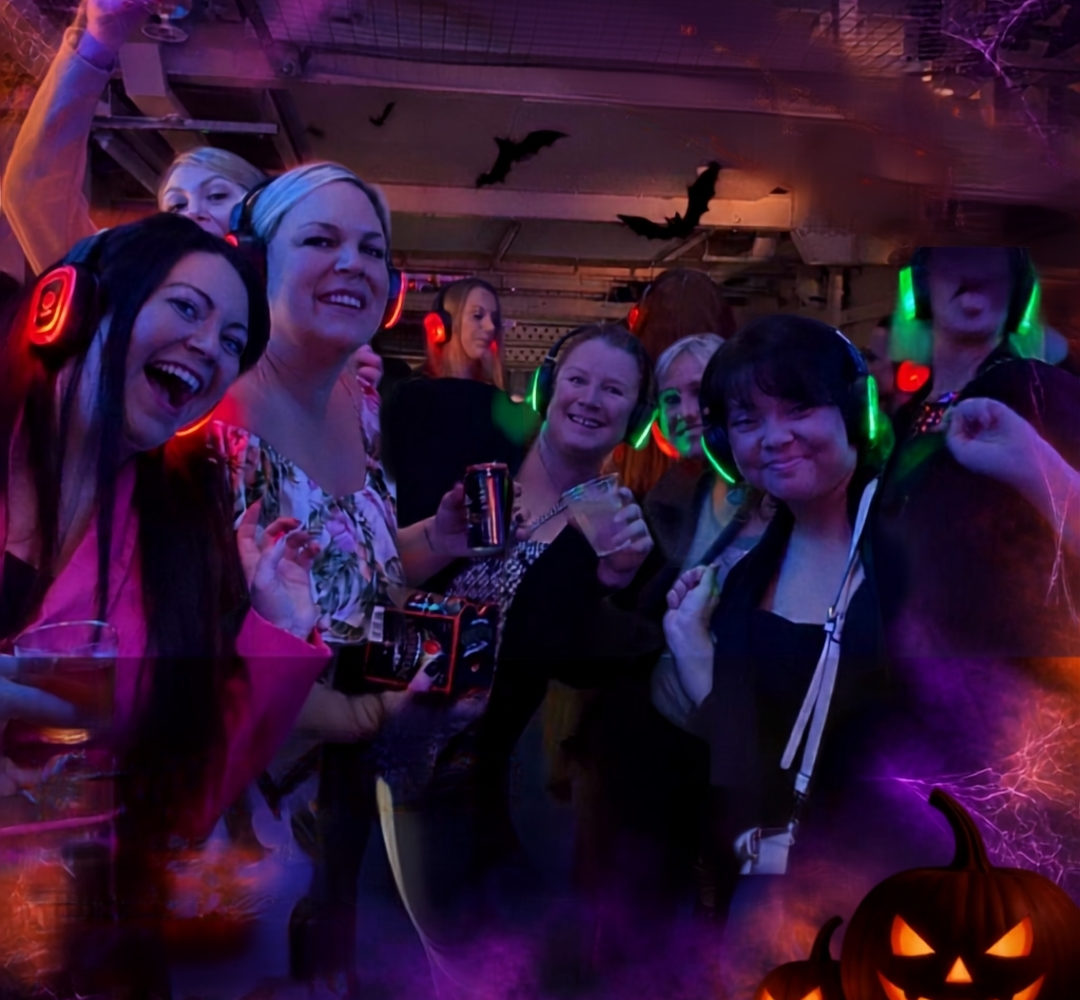 Guests wearing glowing headphones at Halloween Silent Disco in Shepton Mallet Prison